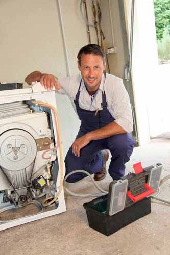 A repairman works on an appliance